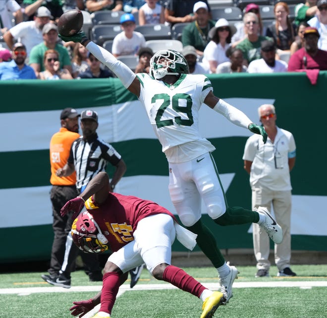 East Rutherford, NJ -- August 10, 2024 -- Carrick Bernard-Converse of the Jets breaks up a pass intended for Olamide Zaccheaus of the Commanders in the first half as the Washington Commanders came to MetLife Stadium to play the New York Jets in the first press season game of the 2024 season.