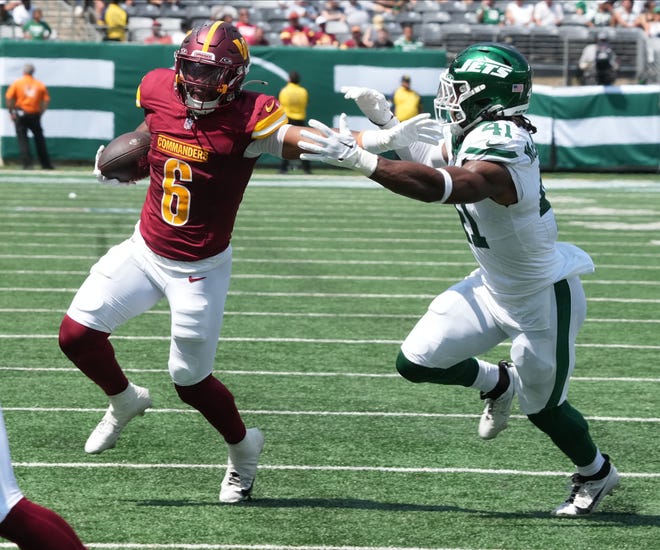 East Rutherford, NJ -- August 10, 2024 -- Michael Wiley of the Commanders is pursued by Marcelino McCrary-Ball of the Jets in the second half as the Washington Commanders came to MetLife Stadium to play the New York Jets in the first press season game of the 2024 season. The Jets topped the Commanders 20-17.