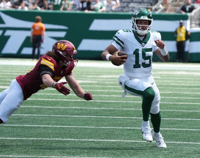 East Rutherford, NJ -- August 10, 2024 -- Jets quarterback Adrian Martinez runs for a first down late in the second half as the Washington Commanders came to MetLife Stadium to play the New York Jets in the first press season game of the 2024 season. The Jets topped the Commanders 20-17.