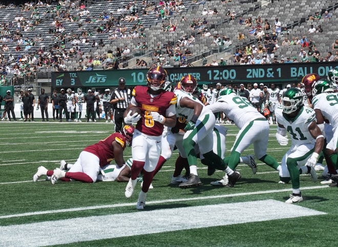 East Rutherford, NJ -- August 10, 2024 -- Michael Wiley scores a Commander TD in the second half as the Washington Commanders came to MetLife Stadium to play the New York Jets in the first press season game of the 2024 season. The Jets topped the Commanders 20-17.