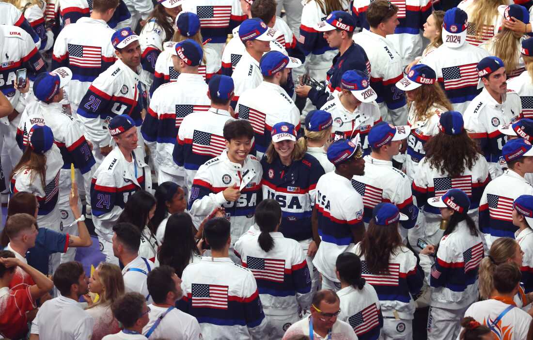 In a sea of U.S. athletes, flag bearer Katie Ledecky poses with her fellow American competitors during the closing ceremony of the Olympic Games.