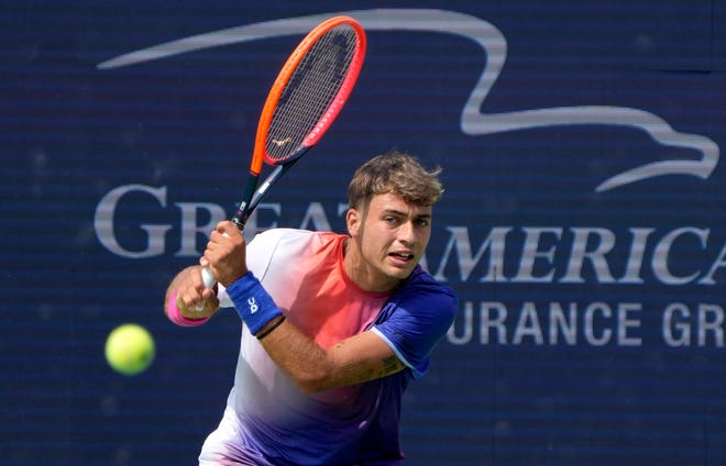 Flavio Cobolli of Italy makes a hit to Tommy Paul of the U.S.A. in the men's singles round 1 during the Cincinnati Open at the Lindner Family Tennis Center in Mason on Monday, August 12, 2024. Cobolli won 6-2, 4-6, 7-5.