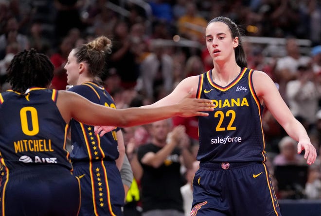 Indiana Fever guard Caitlin Clark (22) and guard Kelsey Mitchell (0) celebrate during the first half of a game Sunday, Aug. 18, 2024, at Gainbridge Fieldhouse in Indianapolis.