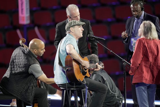 James Taylor warms up during the first day of the Democratic National Convention at the United Center. The DNC program will feature President Joe Biden and Former Secretary of State Hillary Clinton during Monday's ceremonies.