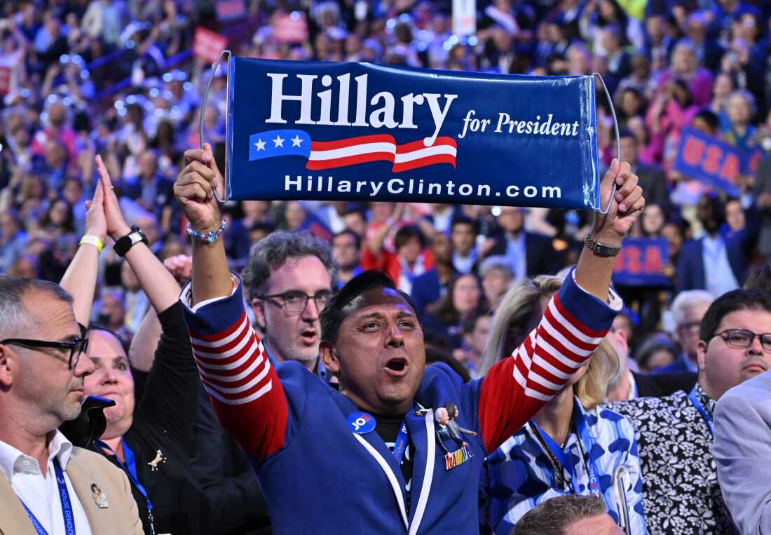 An attendee holds a 2016 banner 