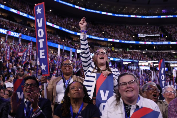 Delegates cheer former President Barack Obama as he addresses the...