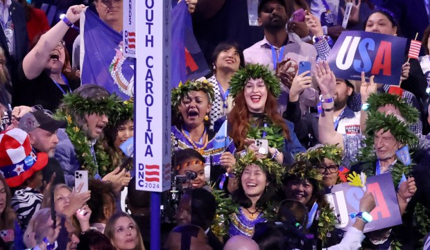 Northern Mariana Islands delegates cheer during roll call on Aug....