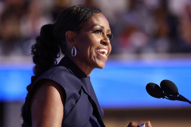 Former first lady Michelle Obama addresses the delegates on Aug....