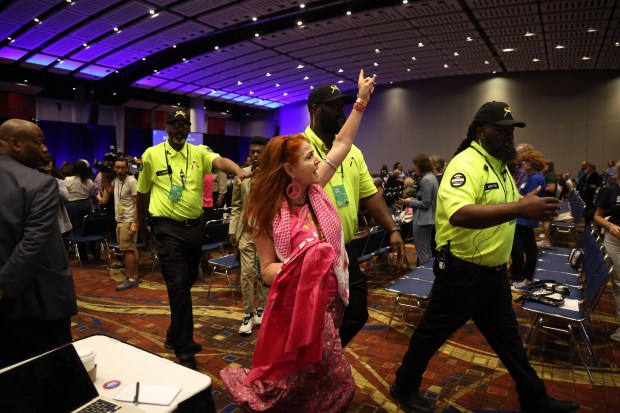 A Code Pink activists is lead out of the Women’s...