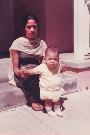 In an undated photo, Vice President Kamala Harris is held by her mother Shyamala Gopalan.