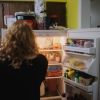 Annalise and Ellie Currence stand at the fridge deciding on dinner at their home in Belton, Mo., on July 17.