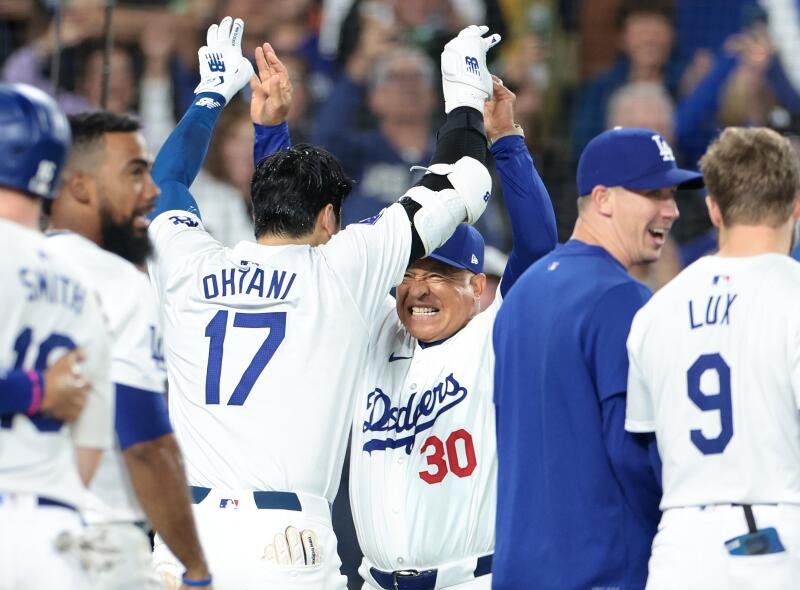 Shohei Ohtani celebrates with manager Dave Roberts after his grand slam.