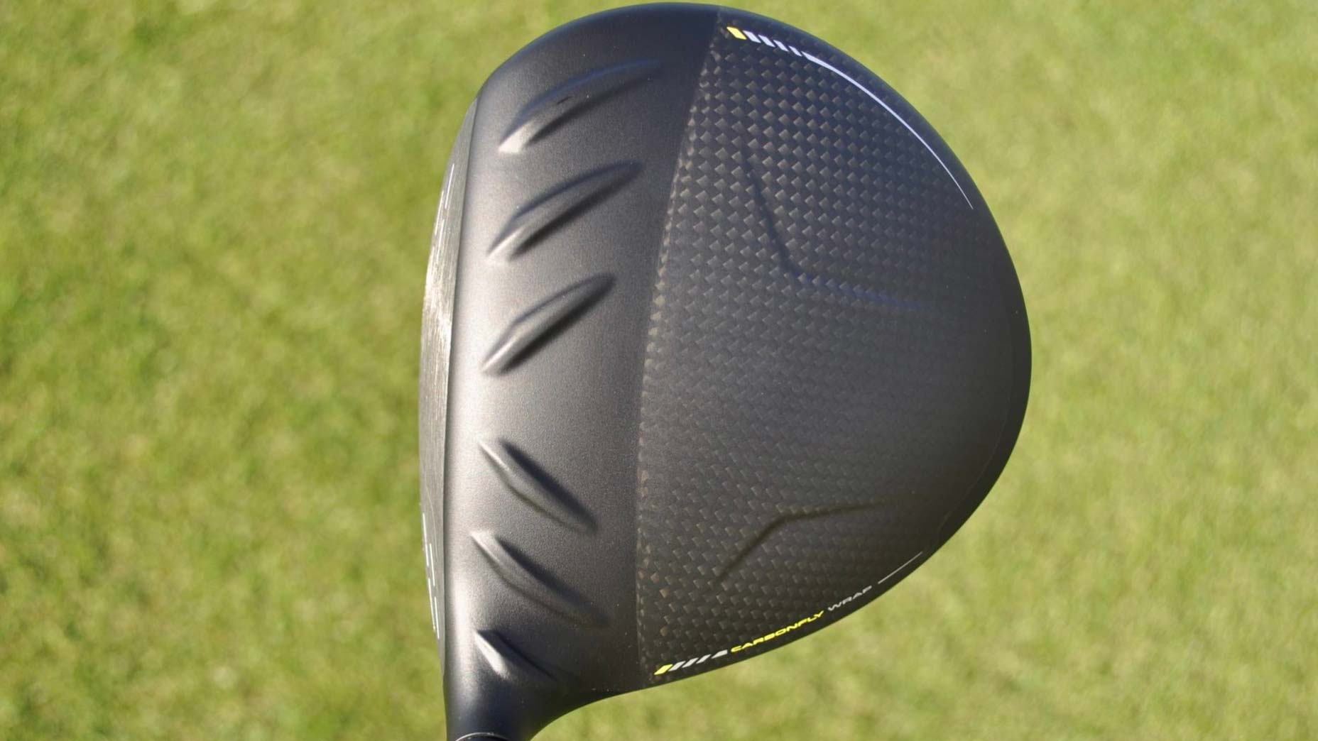 A Ping G430 MAX 10K driver at address seen on a golf course