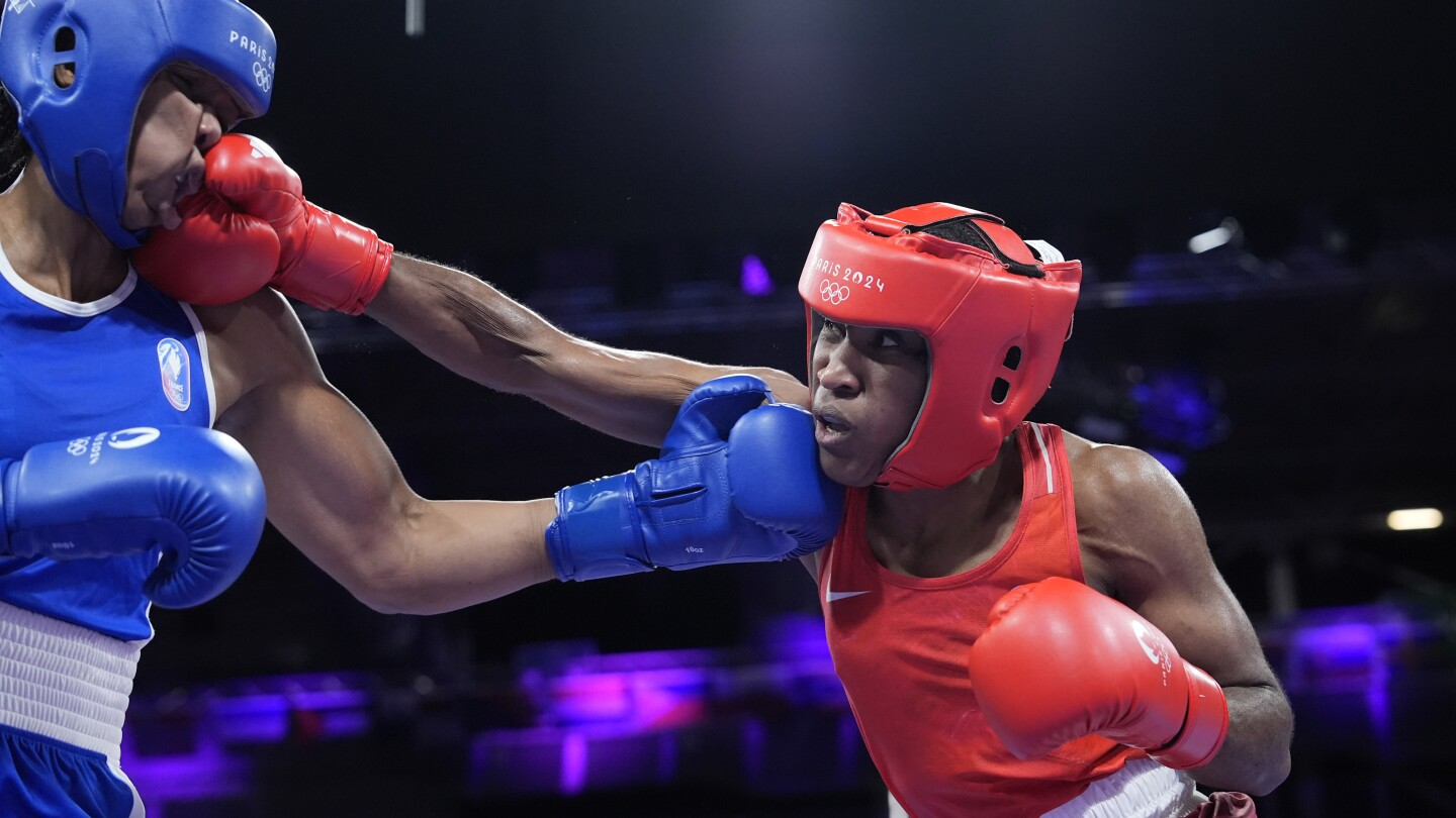 Boxer Cindy Ngamba becomes first athlete competing as a refugee to clinch an Olympic medal