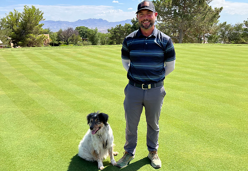 Bill Newton and dog Meeko on sunny greens at Coronado Country Club