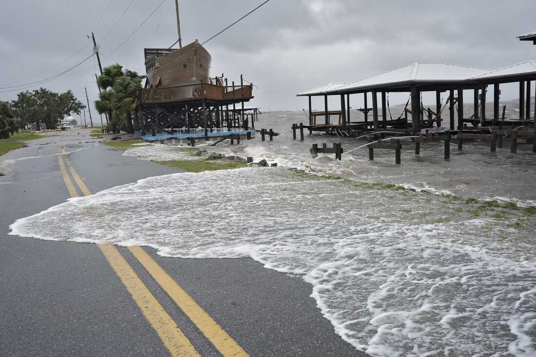 Storm surge breaks over a small sea wall near boat docks in Horseshoe Beach, Florida, on Monday, August 5.