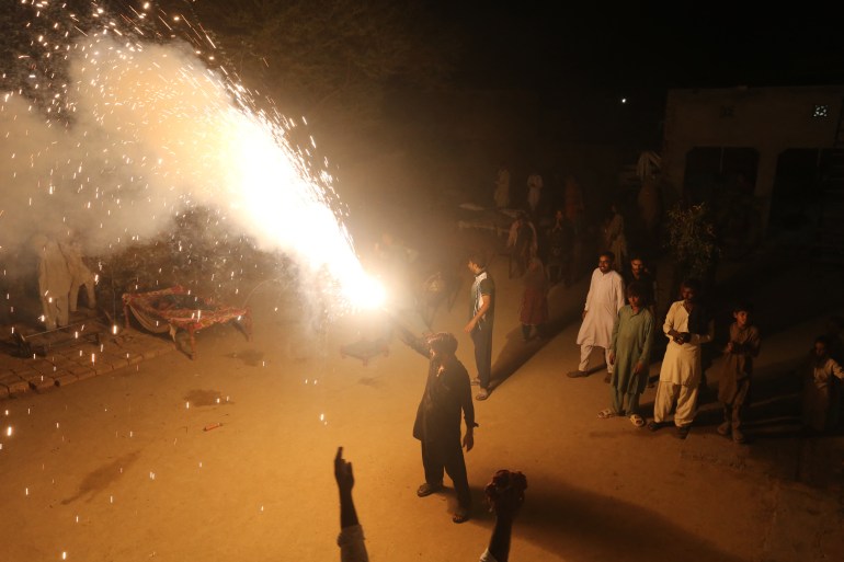 Supporters and family members of Pakistani athlete Arshad Nadeem celebrate after his win in the men's javelin throw final of the athletics event at the Paris 2024 Olympic Games, at Mian Channu in Khanewal District on August 9, 2024. - Pakistan's Arshad Nadeem won the Olympic men's javelin title in Paris on August 8, his country's first individual gold at a Summer Games. (Photo by Shahid Saeed MIRZA / AFP)