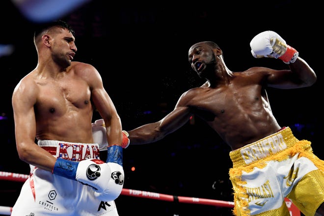 Terence Crawford, right, winds up to trade punches with Amir Khan during their WBO welterweight title fight at Madison Square Garden in New York on April 20, 2019.