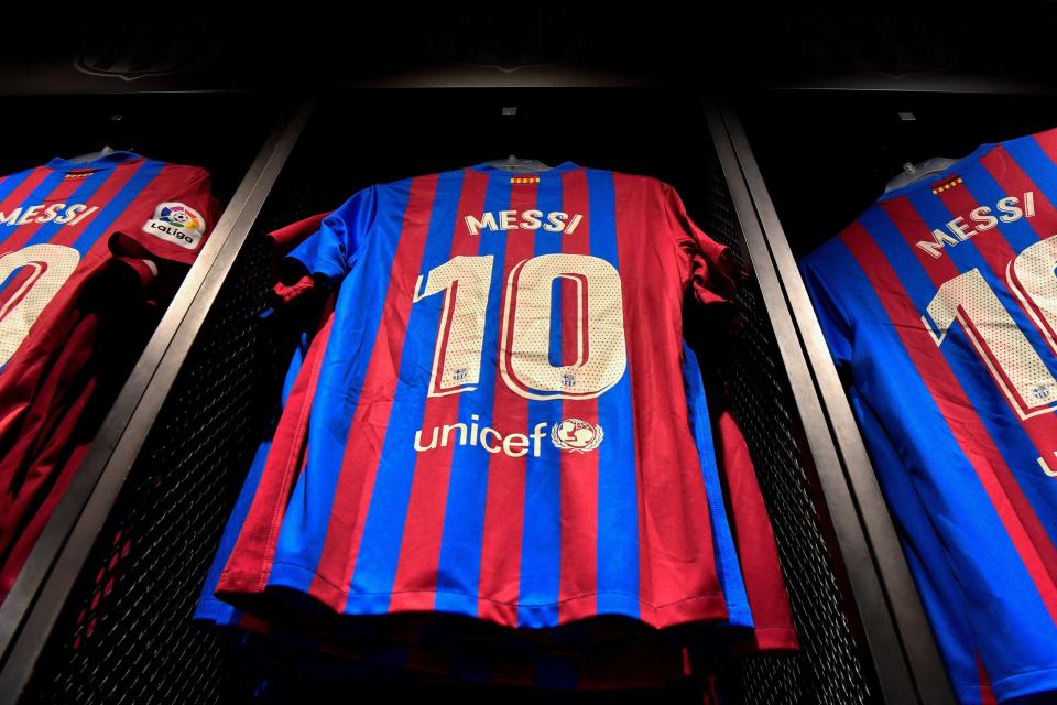 Football jerseys bearing the name of Barcelona's Argentinian forward Lionel Messi are displayed for sale at the official store of the Camp Nou Stadium in Barcelona on August 7, 2021. - Messi will take part in a Barcelona press conference on August 8, three days after the club announced he was leaving after 21 years, the Spanish giants said.