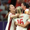 The Canadian women's soccer team celebrates during their win over Colombia Wednesday. The team has advanced into the Olympic quarterfinals amid an ongoing spying scandal involving the team's now-suspended head coach.