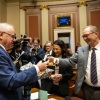 Rep. Paul Torkleson, R-Hanska, accepts an apple blondie from Gov. Tim Walz before the Minnesota House begins their session at the State Capitol on Monday, Feb. 12, 2024.