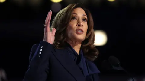 Getty Images Kamala Harris stands at a lectern as she gives a speech at the 2024 Democratic National Convention in Chicago