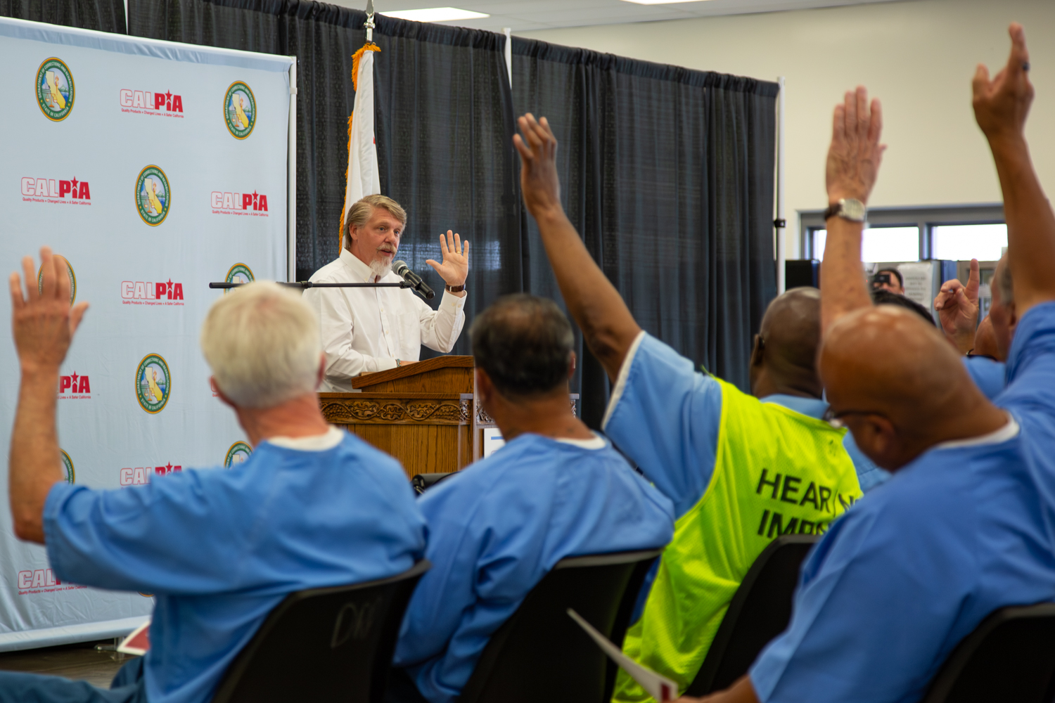 CALPIA General Manager Bill Davidson at a lectern during a graduation ceremony.