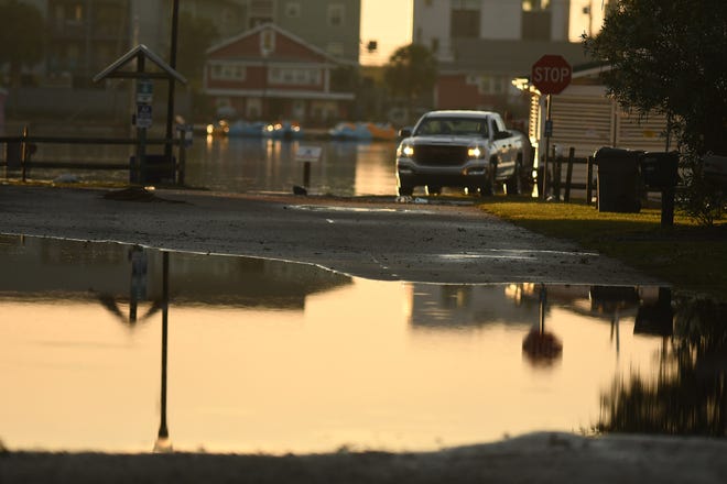 Residents and others look over the standing flood waters that remain around the Carolina Beach Lake area Tuesday Sept. 17, 2024 in Carolina Beach, N.C. KEN BLEVINS/STARNEWS