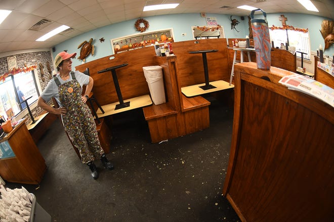 Kate Weiss walks through Kate's Pancake House in Carolina Beach Tuesday Sept. 17, 2024 in Carolina Beach, N.C. Flood waters took over the restaurant off Lake Park Blvd after a storm system moved through the area Monday. KEN BLEVINS/STARNEWS