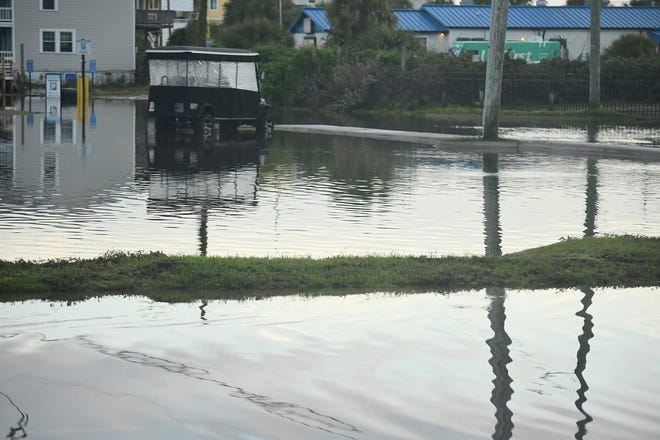 Residents and others look over the standing flood waters that remain around the Carolina Beach Lake area Tuesday Sept. 17, 2024 in Carolina Beach, N.C. KEN BLEVINS/STARNEWS