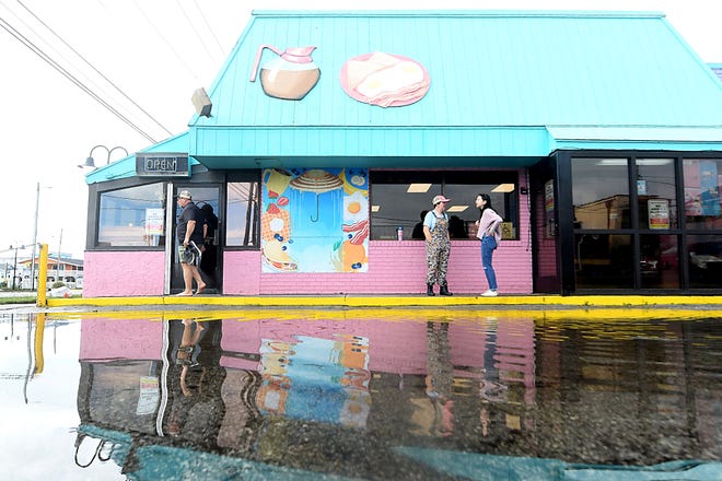 Kate Weiss walks through Kate's Pancake House in Carolina Beach Tuesday Sept. 17, 2024 in Carolina Beach, N.C. Flood waters took over the restaurant off Lake Park Blvd after a storm system moved through the area Monday. KEN BLEVINS/STARNEWS