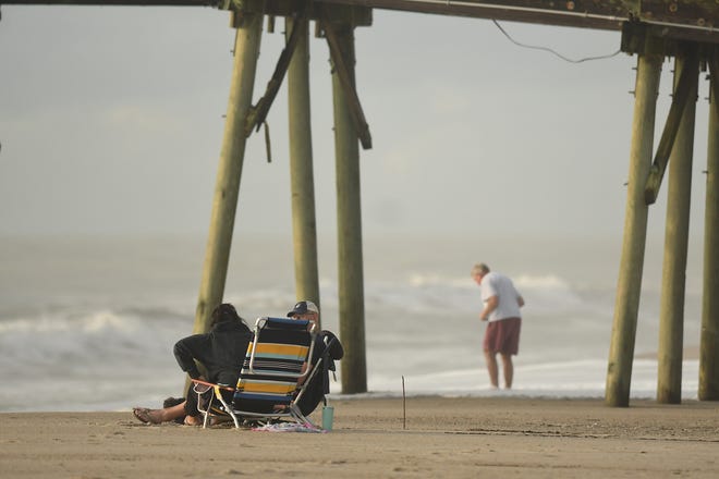 People enjoy the beach early Tuesday, Sept. 17, 2024, in Kure Beach. KEN BLEVINS/STARNEWS