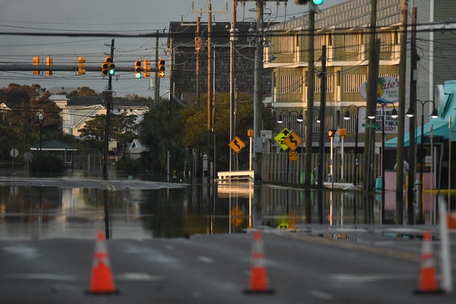 Residents and others look over the standing flood waters that remain around the Carolina Beach Lake area Tuesday Sept. 17, 2024 in Carolina Beach, N.C. KEN BLEVINS/STARNEWS