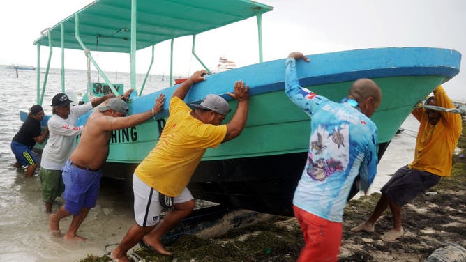 People secure their boats ahead of the arrival of soon-to-be Hurricane Helene in Cancun, Quintana Roo state, Mexico on September 24, 2024. (Photo by Elizabeth Ruiz / AFP) (Photo by ELIZABETH RUIZ/AFP via Getty Images)