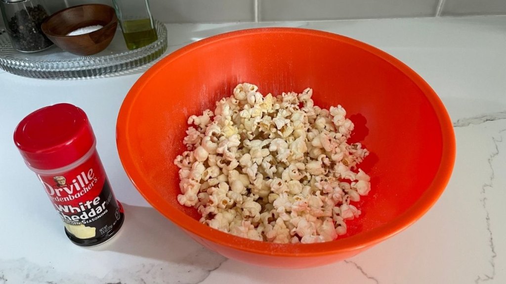 bowl with Orville Redenbacher's White Cheddar popcorn seasoning on popcorn