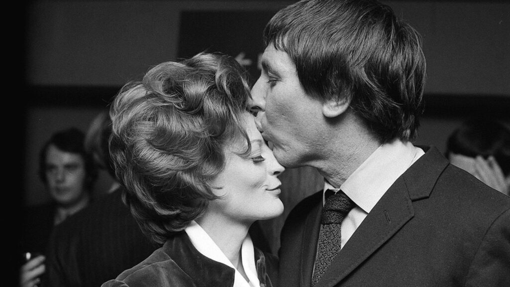 Black and white photo of Maggie Smith in 1970 with her first husband Robert Stephens celebrating her Oscar winning award for The Prime of Miss Jean Brodie.