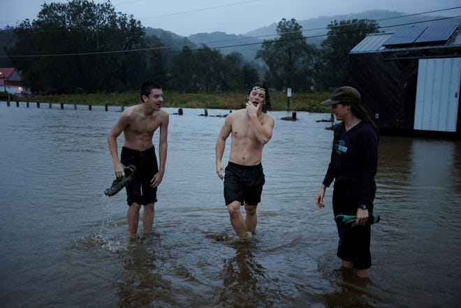 Residents play in flood waters as Hurricane Helene approaches in the North Carolina mountains, in Valle Crucis, North Carolina, U.S. September 26, 2024.