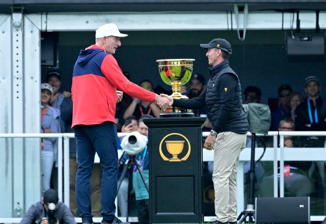 USA captain Jim Furyk and International team captain Mike Weir shake hands before the first round of The Presidents Cup golf tournament on Sept. 26, 2024