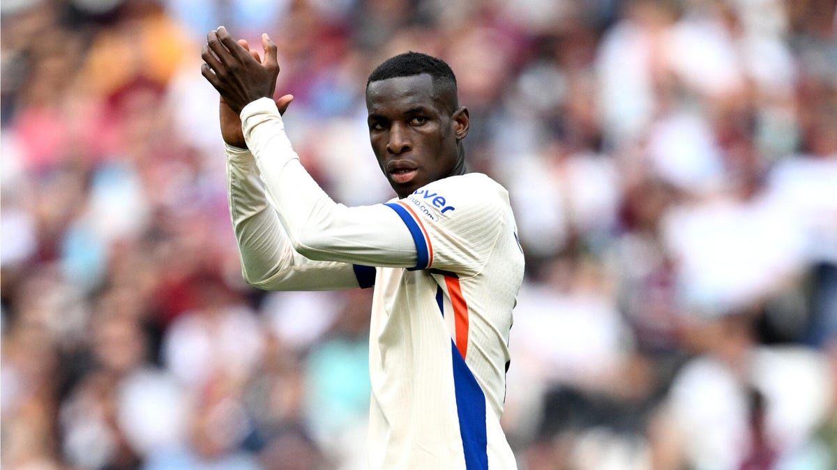 Side-on image of Chelsea striker Nicolas Jackson applauding with raised hands.