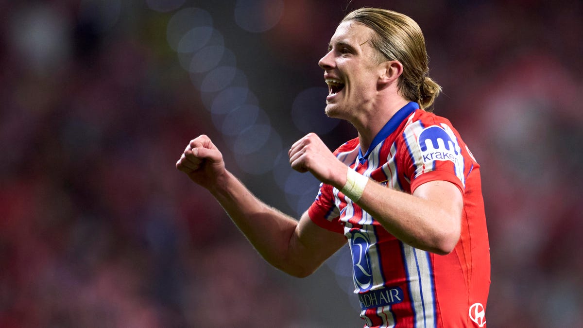 Atletico Madrid midfielder Conor Gallagher celebrating, shouting, with both hands raised in fists.