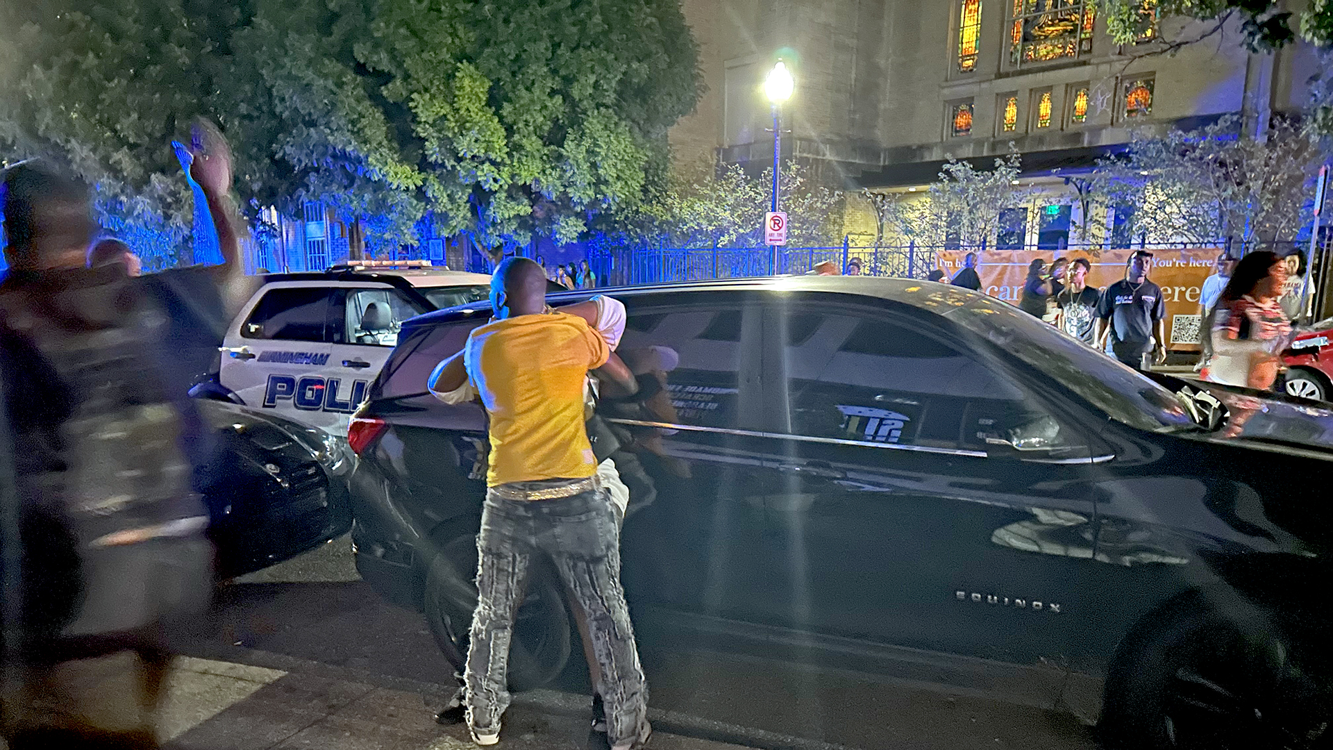 An unidentified man attempts to calm down a woman in the aftermath of a mass shooting in the 2000 block of Magnolia Avenue in Birmingham’s Five Points South neighborhood late Saturday, Sept. 21, 2024.