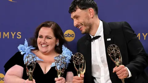 Getty Images Jessica Gunning and Richard Gadd smiling and holding their four Emmy Awards