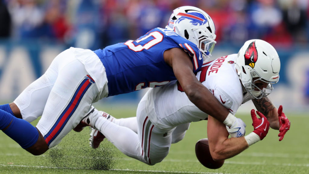 Arizona Cardinals TE Trey McBride is tackled by Greg Rousseau...