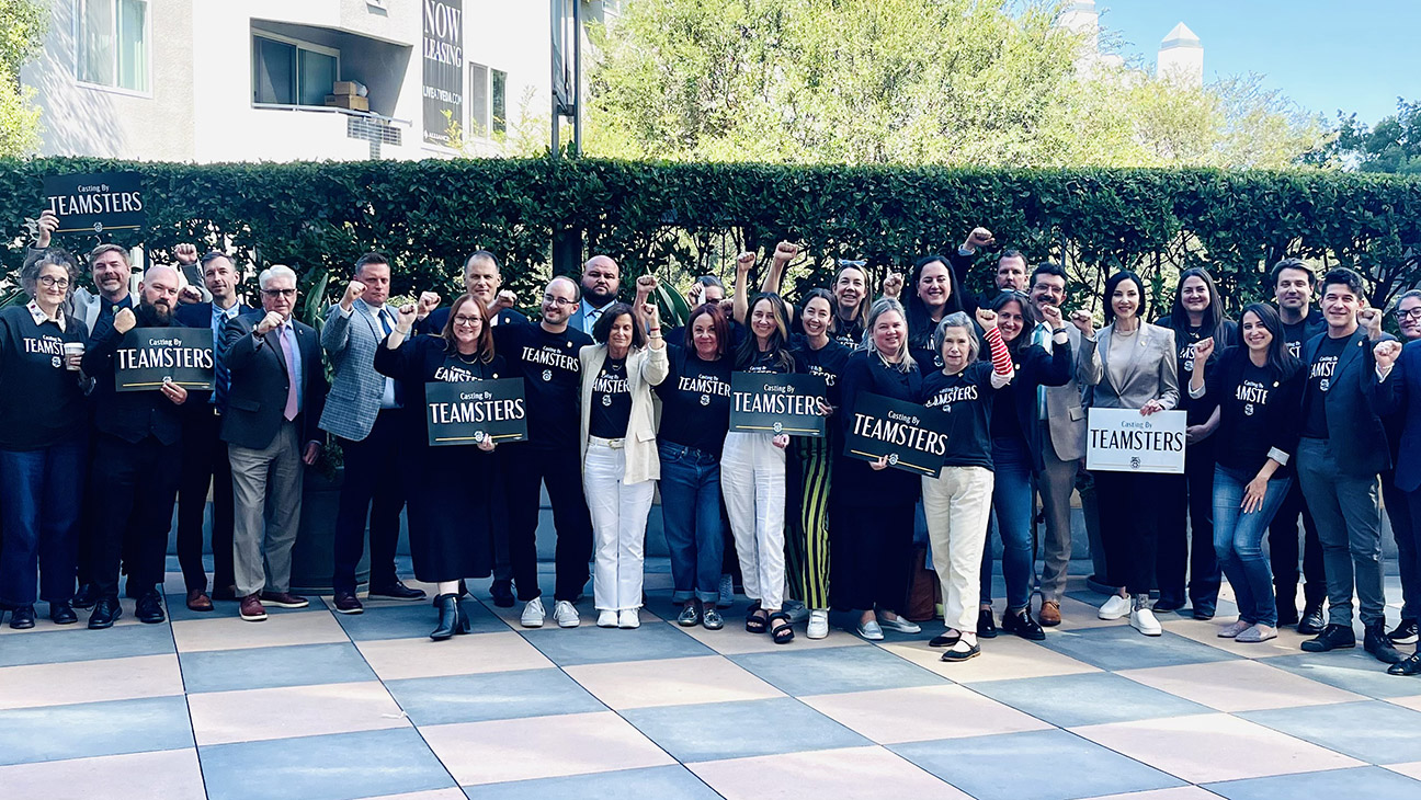 Teamsters Local 399 negotiators pose in front of the Alliance of Motion Picture and Television Producers' Sherman Oaks offices.