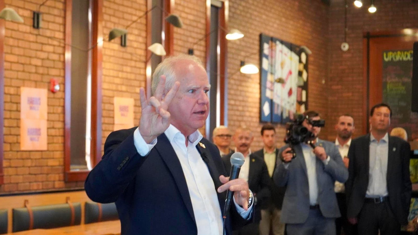 Gov. Tim Walz gives a 'Forks Up' during surprise appearance at Snakes & Lattes