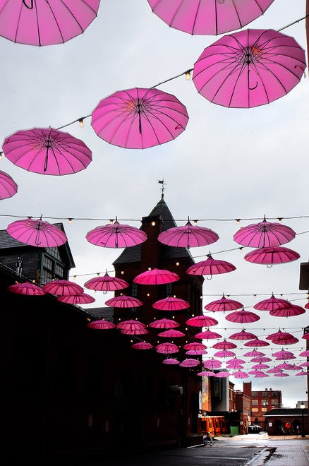 The Pink Power Parasol Project is now hanging in the Cherry Lane Alley behind Central Market in York. About 100 parasols were hung Thursday, September 26, 2024, and will remain there throughout October to bring awareness to Breast Cancer Awareness Month. The North George Street bridge over the Codorus Creek is also decorated. Bil Bowden photo