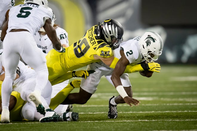 Oregon Ducks inside linebacker Bryce Boettcher tackles Michigan State Spartans quarterback Aidan Chiles as the Ducks host the Spartans Friday, Oct. 4, 2024 at Autzen Stadium in Eugene, Ore.