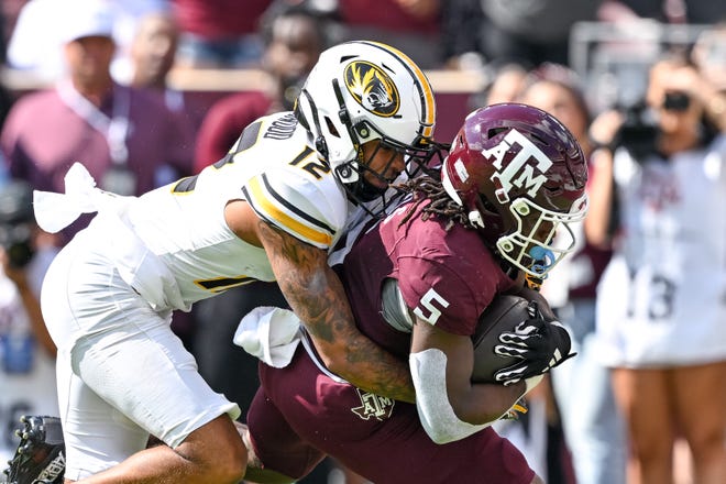 Texas A&M running back Amari Daniels is tackled by Missouri cornerback Dreyden Norwood in the Aggies' 41-10 win Saturday at Kyle Field. Daniels finished the day with a pair of rushing touchdowns and A&M improved to 3-0 in SEC play.