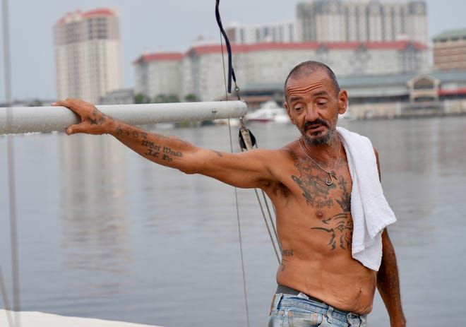 Joe Malinowski stands aboard his 22-foot sailboat Seashell in Tampa, Florida, on Tuesday, Oct. 8, 2024, as Hurricane Milton approached. Malinowski rode Helene out aboard his boat and hoped to the same again with Milton.