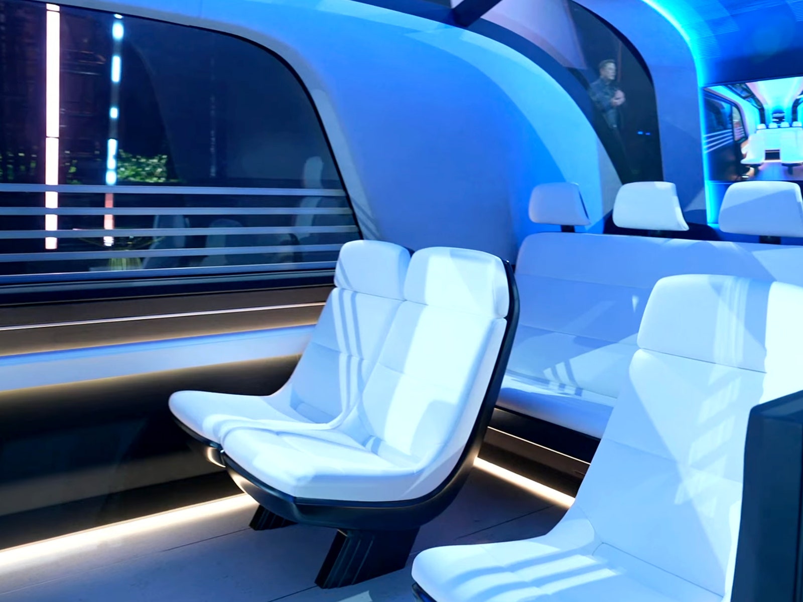 Interior shot of the Tesla Robovan showing two rows of white leather seats.